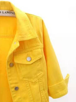 Citrus yellow denim trucker jacket with cropped sleeves and button pockets.
