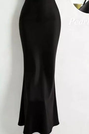 Black satin cowl neck maxi dress with pearl embellishments.