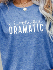Cobalt blue crew neck tee with white text that reads "a little bit DRAMATIC".