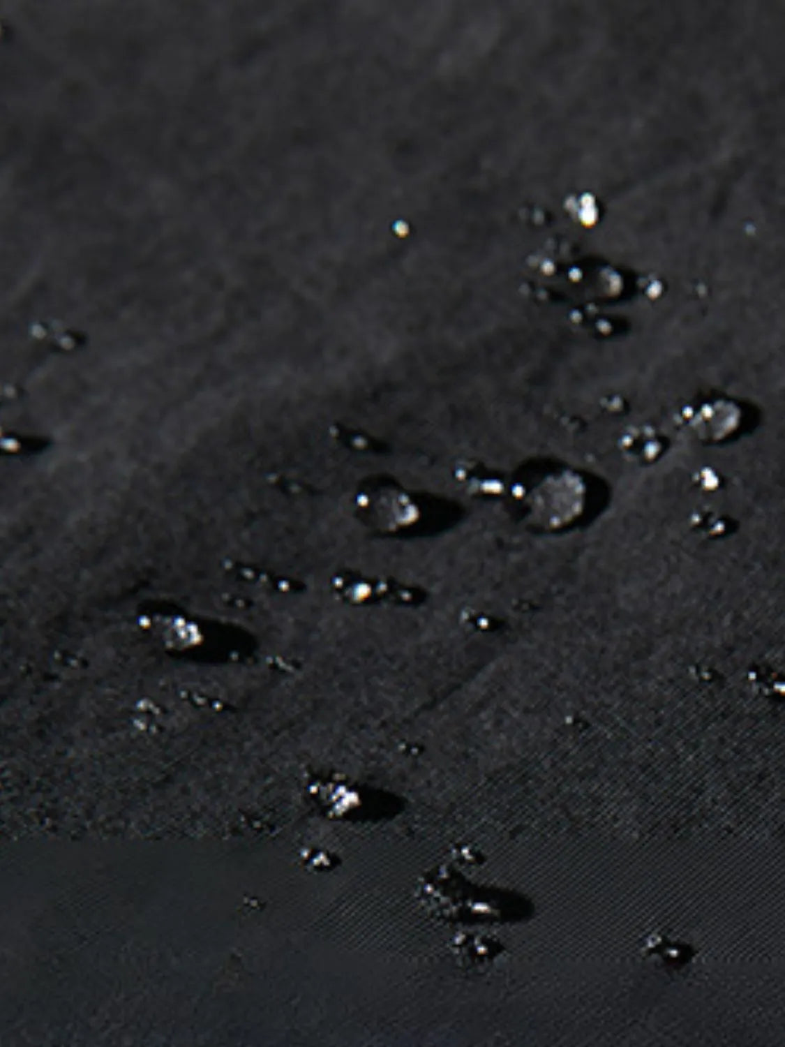 Black oversized cargo trousers with water droplets on fabric