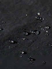 Black oversized cargo trousers with water droplets on fabric