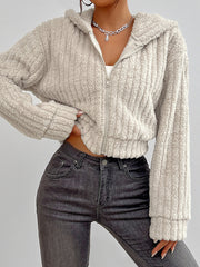 Beige textured cropped teddy zip-up hoodie with a fuzzy material and ribbed cuffs.