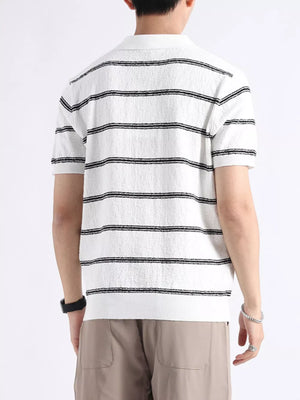 White knit polo shirt with black horizontal stripes and button accents.