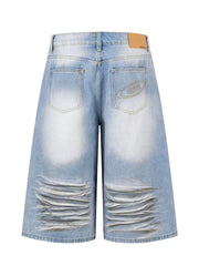 Men's light wash distressed wide-leg capri jeans with whiskering and embroidered back pocket detail.