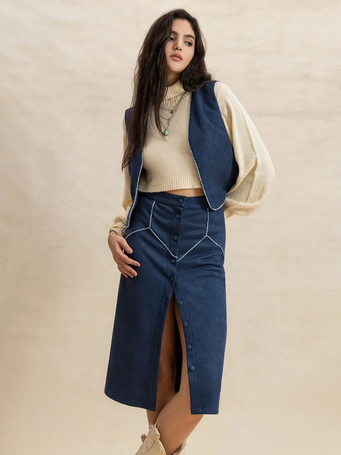 Peacock blue suede vest and button-front midi skirt set with contrast stitching