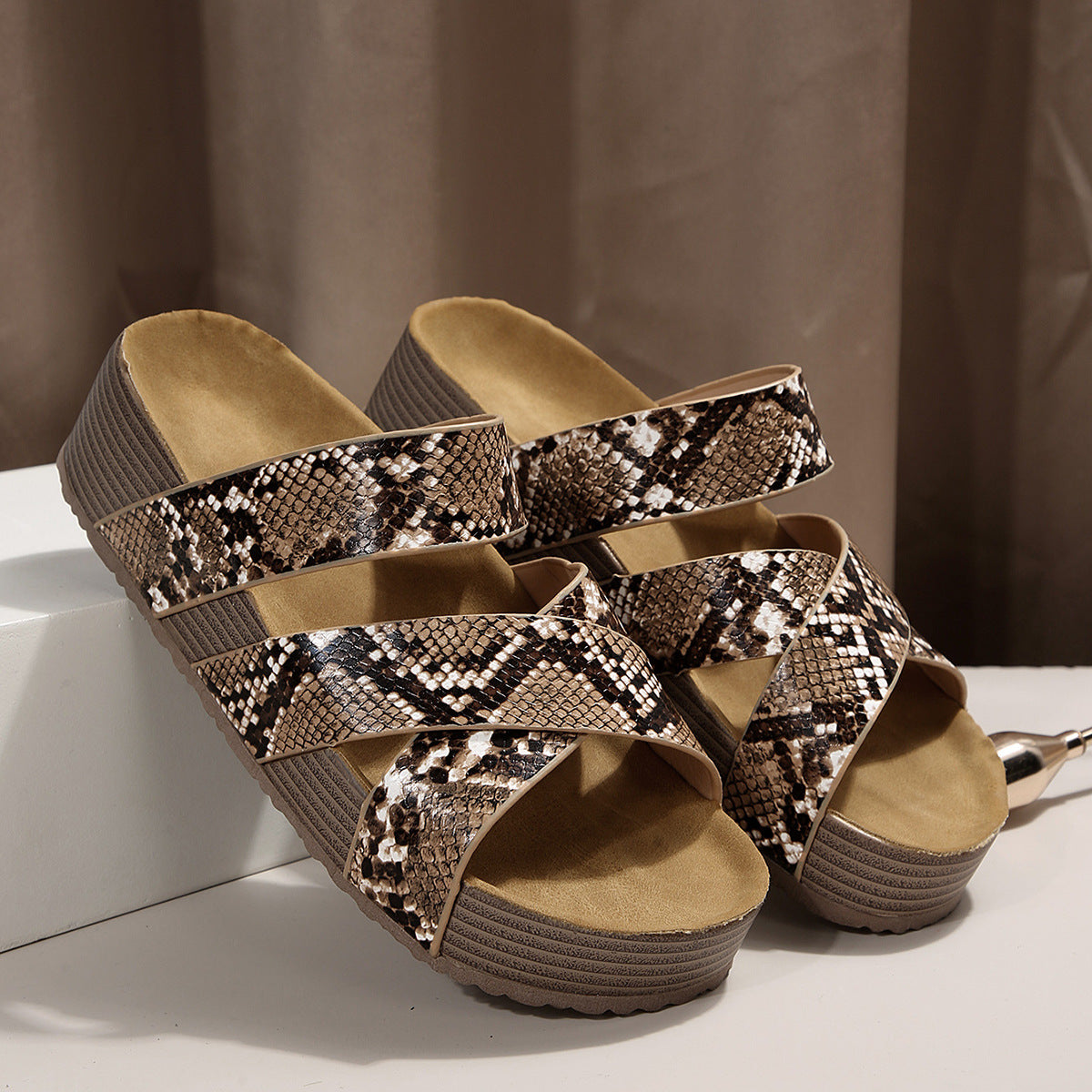 Platform sandals with snake pattern braided straps and a comfortable sole.