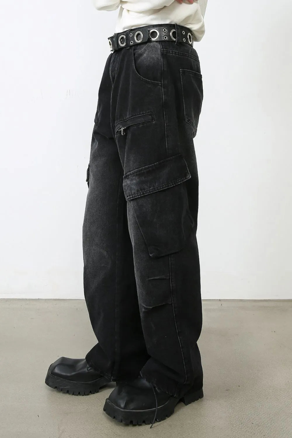 Faded black denim cargo pants with multiple pockets and a relaxed fit.