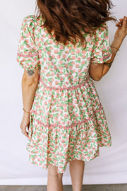 Women's tiered mini dress with floral print, puff sleeves, and pink trim detail.