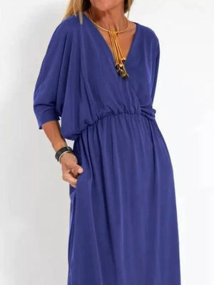 V-neck dolman sleeve maxi dress in dark blue with elastic waist and side slits.