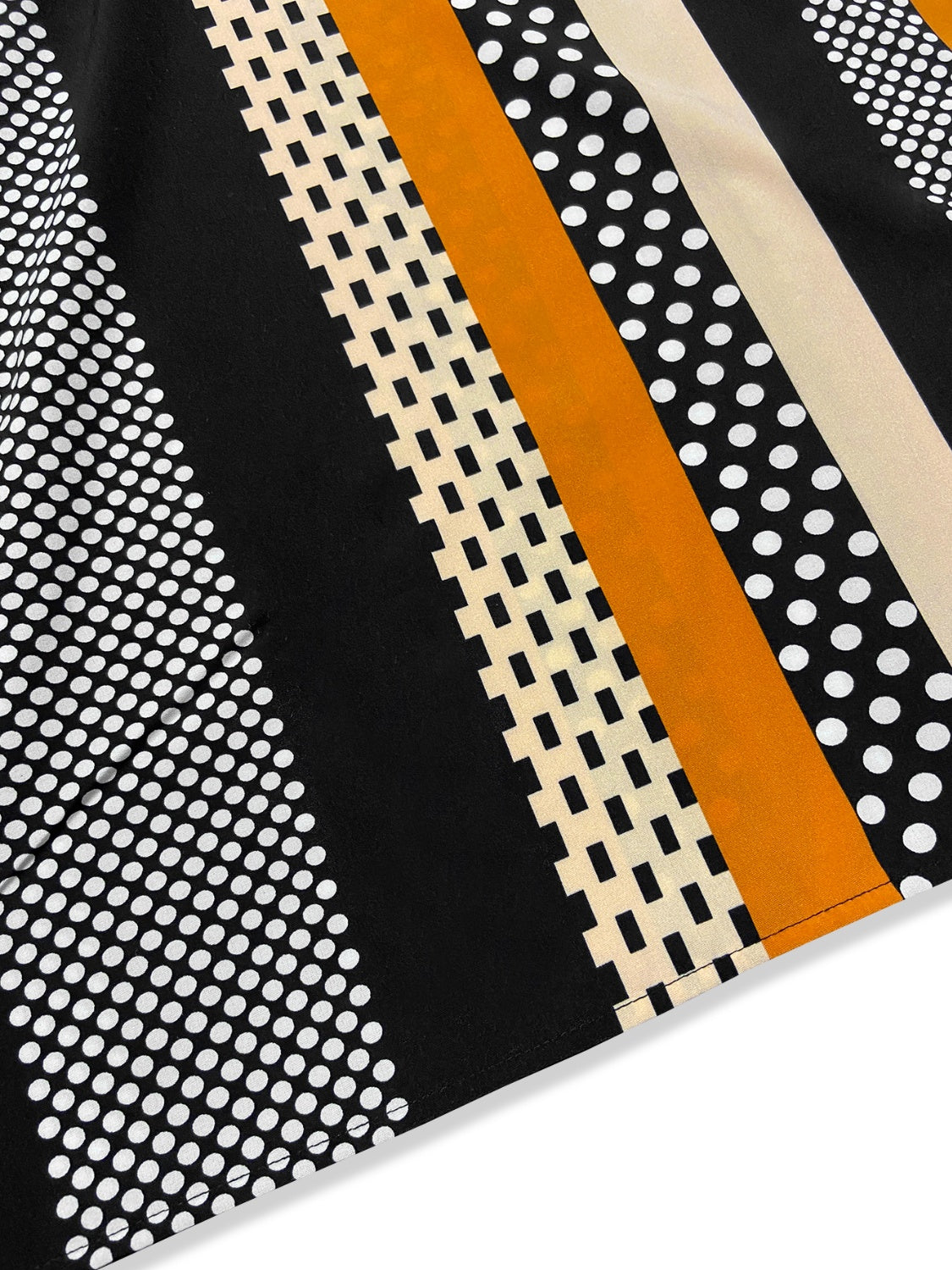 Black asymmetric stripe shoulder top with polka dots and geometric patterns.