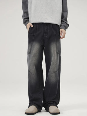 Relaxed fit washed wide-leg jeans in black with cargo pockets and a faded wash.