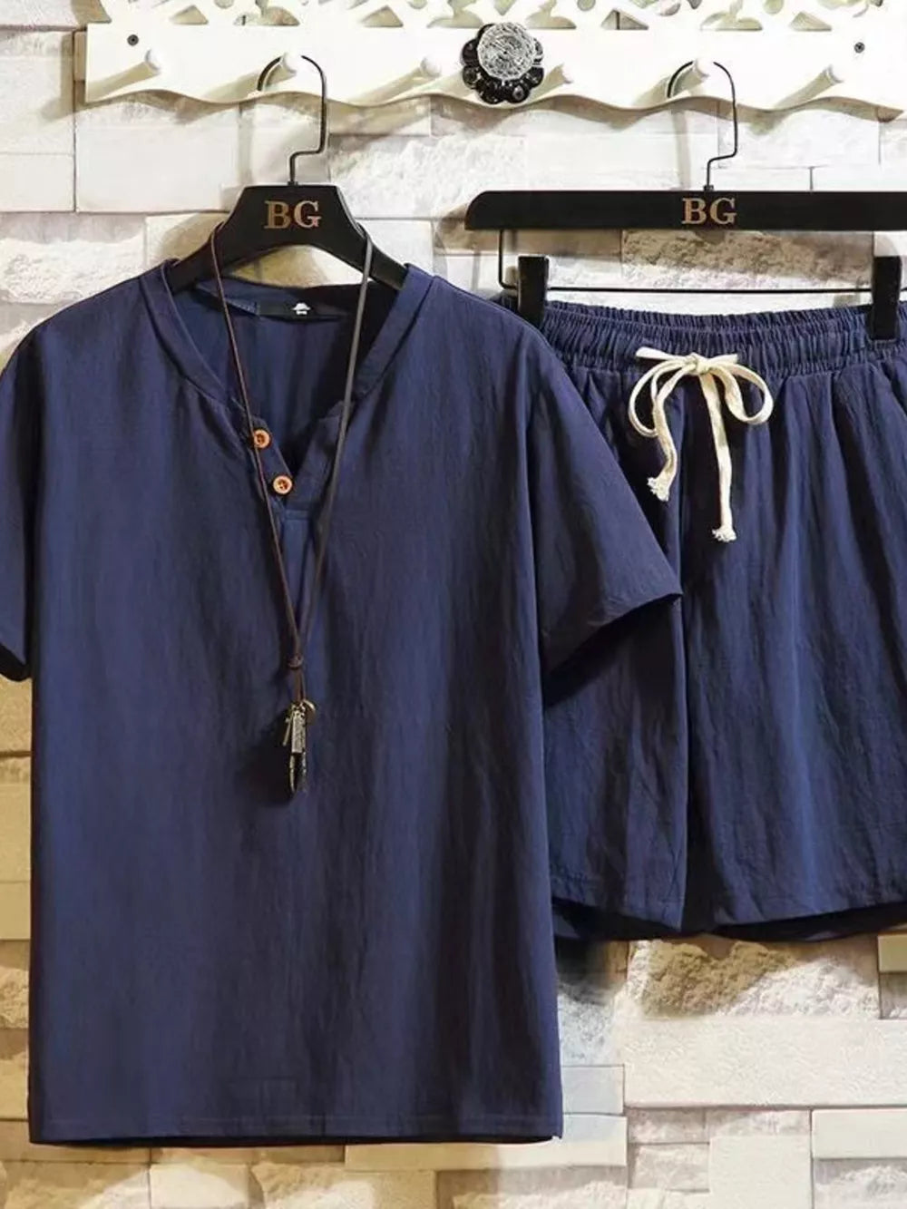 Navy blue cotton two-piece set with henley neckline shirt and drawstring shorts.