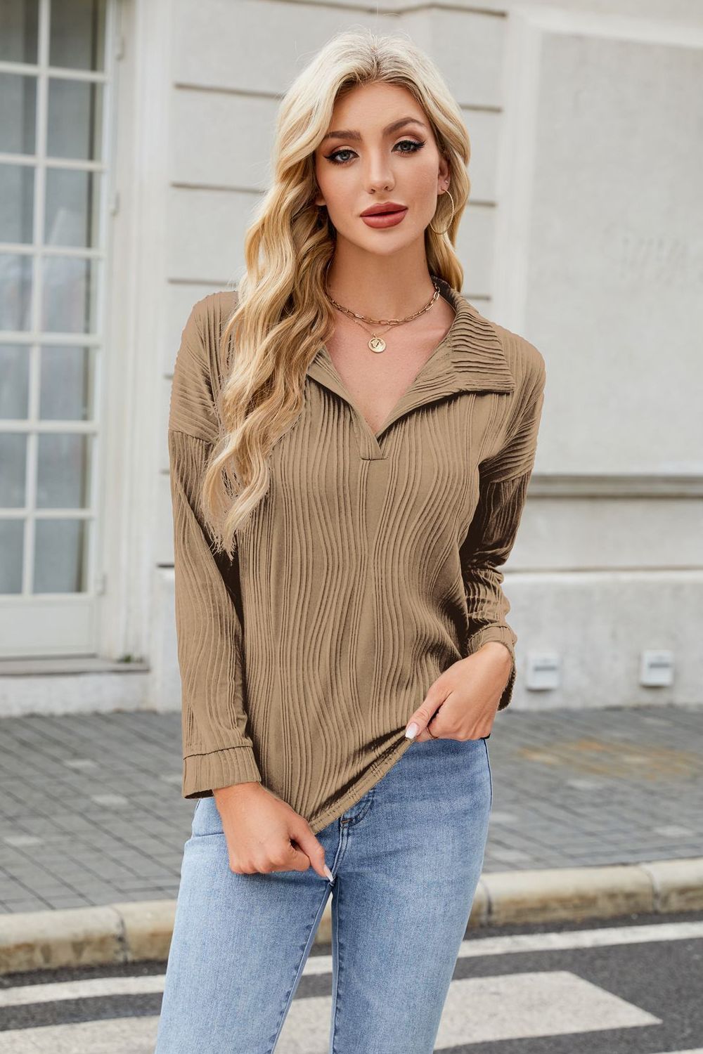 Taupe pleated wave-effect collared long sleeve blouse with a V-neck.