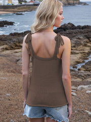 Brown knit tank top with tie straps and deep V-neck, styled with denim shorts.