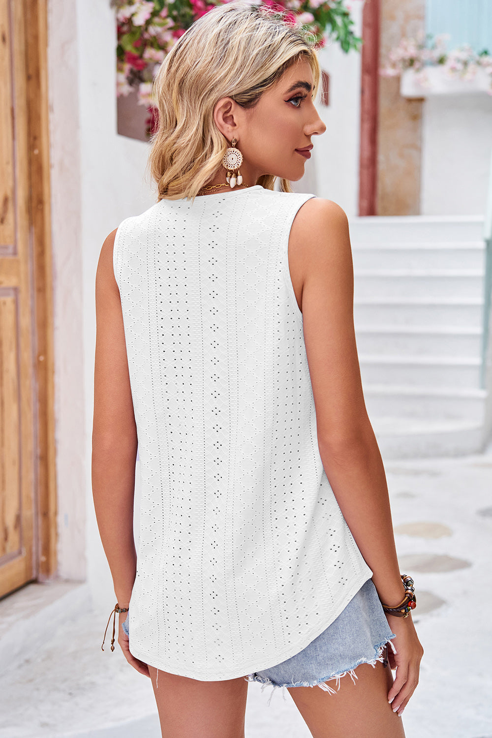 White eyelet lace trim v-neck tank top with a relaxed fit and curved hem.
