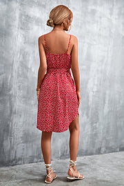 Red daisy print slip dress with spaghetti straps and tie waist, shown from the back.