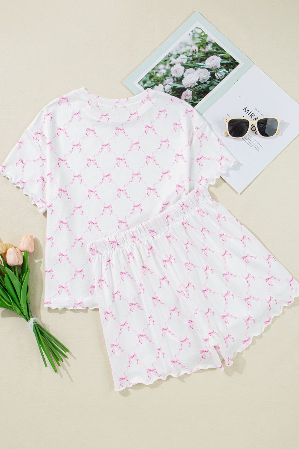 Pink bow print loungewear set with scalloped edges and elastic waist shorts.