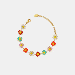 Gold metal bangle bracelet with colorful enamel daisy charms and adjustable chain.