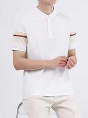 White combed cotton polo shirt with striped accents on the sleeves.