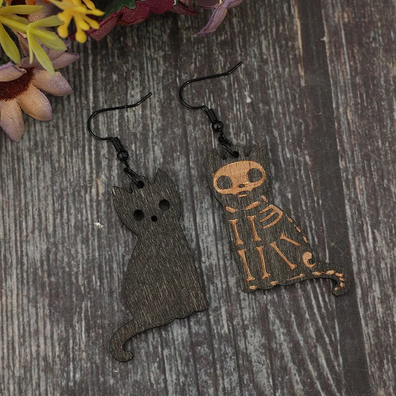 Black laser-cut cat earrings with skeleton detail, made of alloy.