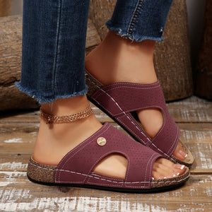 Burgundy perforated pu leather wedge sandals with white stitching and cork sole.
