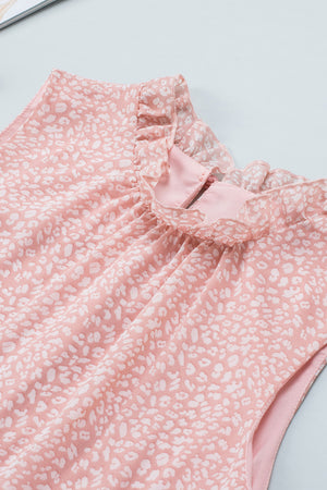 Blush pink sleeveless blouse with white leopard print and ruffled neckline.