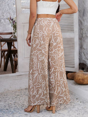 Geometric print wide-leg drawstring trousers in Dust Storm with white floral pattern.