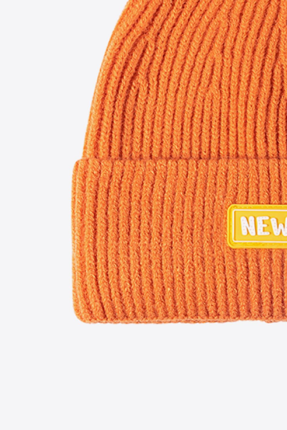 Orange ribbed acrylic beanie with yellow New York patch detail