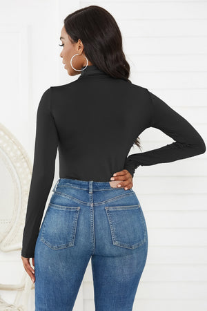 Black long sleeve turtleneck thong bodysuit with a sculpted fit.