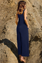 Dark Blue corduroy overalls with wide leg silhouette and pockets.