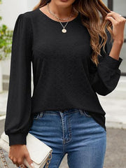 Black perforated puff sleeve blouse with textured fabric and crew neck.