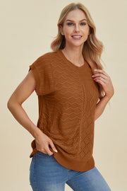Brown knit patchwork sleeveless top with textured patterns and cable knit details.