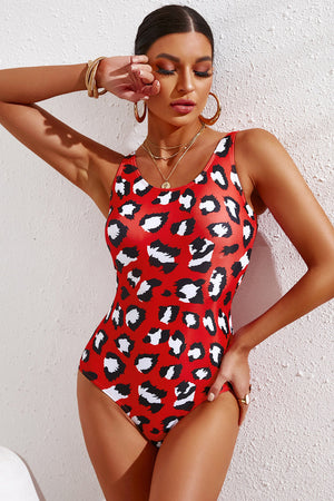 Red leopard print one-piece swimsuit with scoop neck and racerback detail.