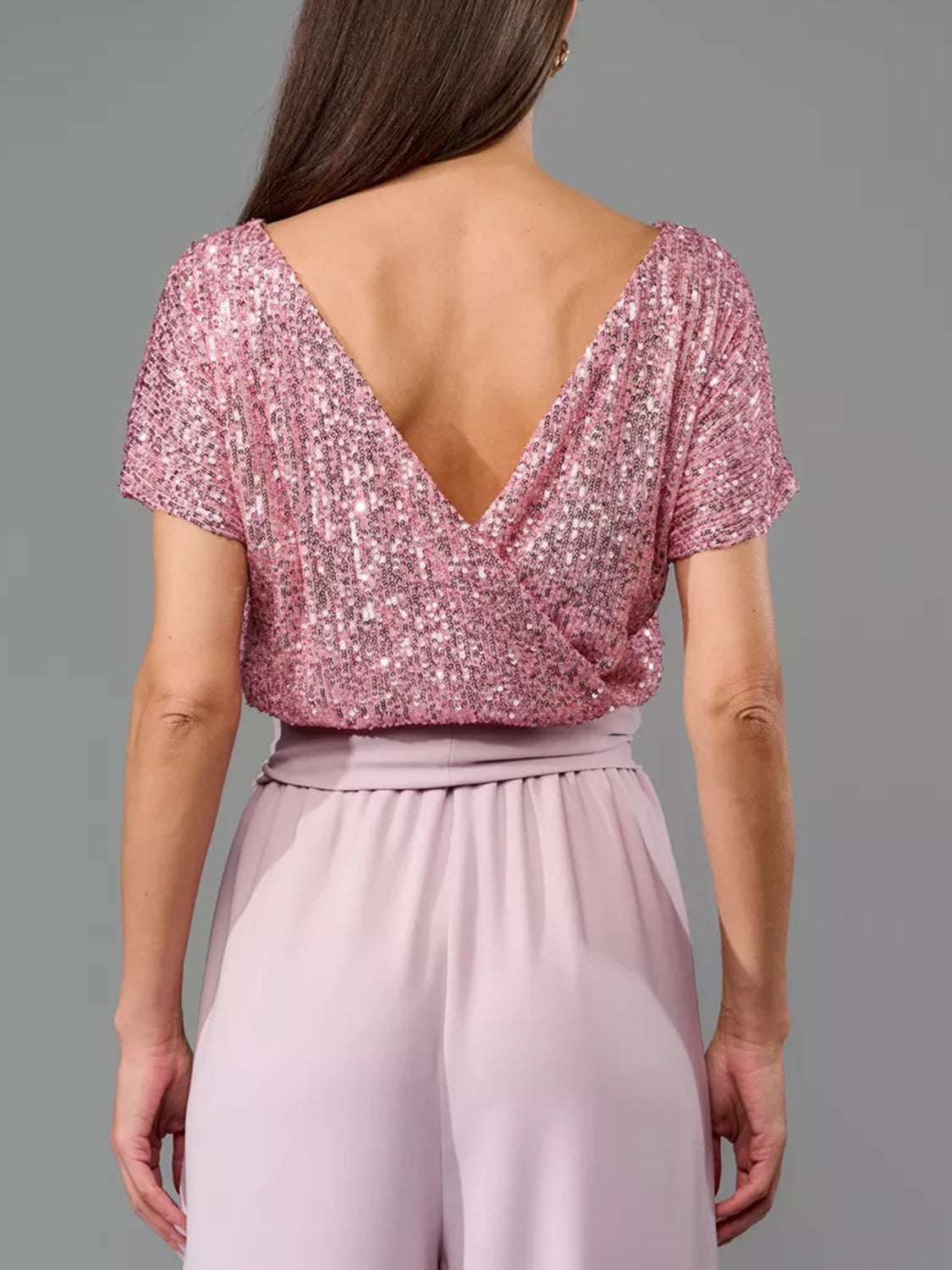 Sequin wrap bodice top with short sleeves and wide leg palazzo pants in dusty pink.