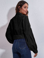 Black corduroy cropped jacket with balloon sleeves and button details.