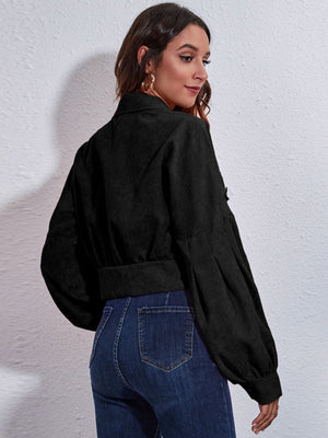 Black corduroy cropped jacket with balloon sleeves and button details.
