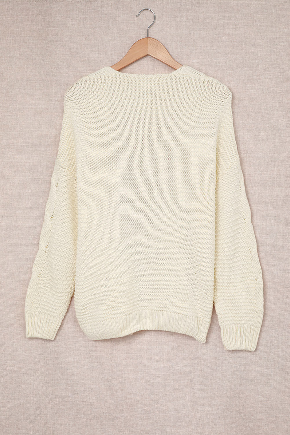 Ivory cable knit acrylic cocoon cardigan with open front and textured sleeves.