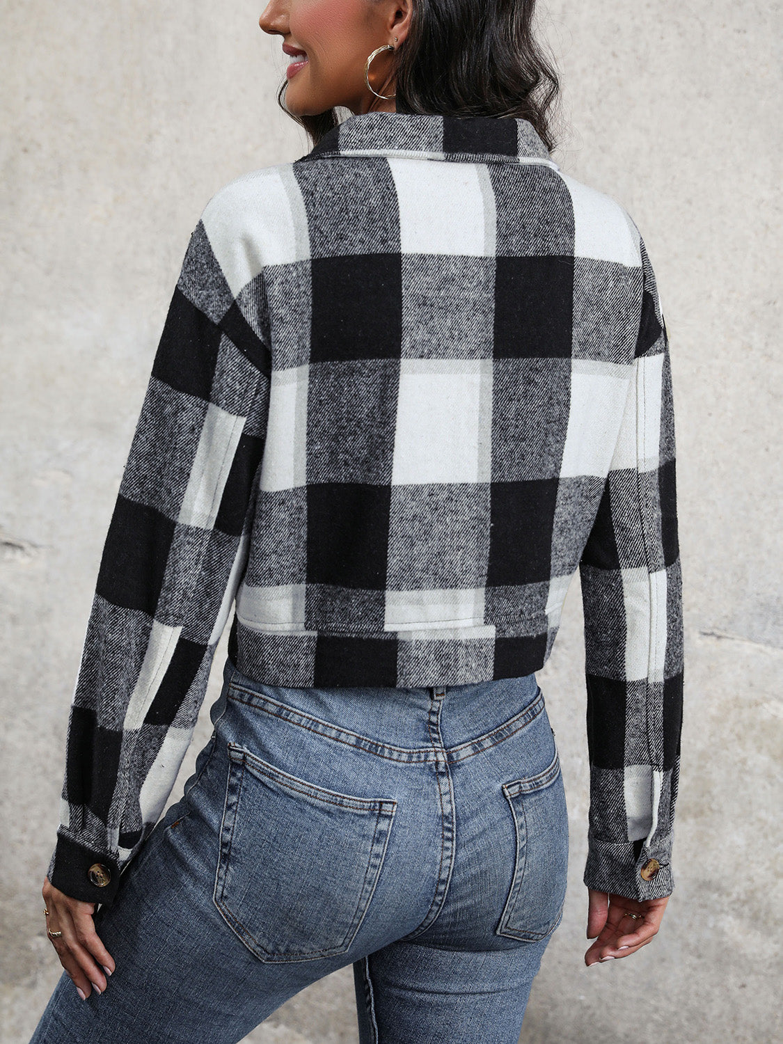 Checked plaid shacket in black and white with buttoned cuffs.