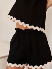 Black linen tank and shorts set with scalloped white trim and smocked waist.