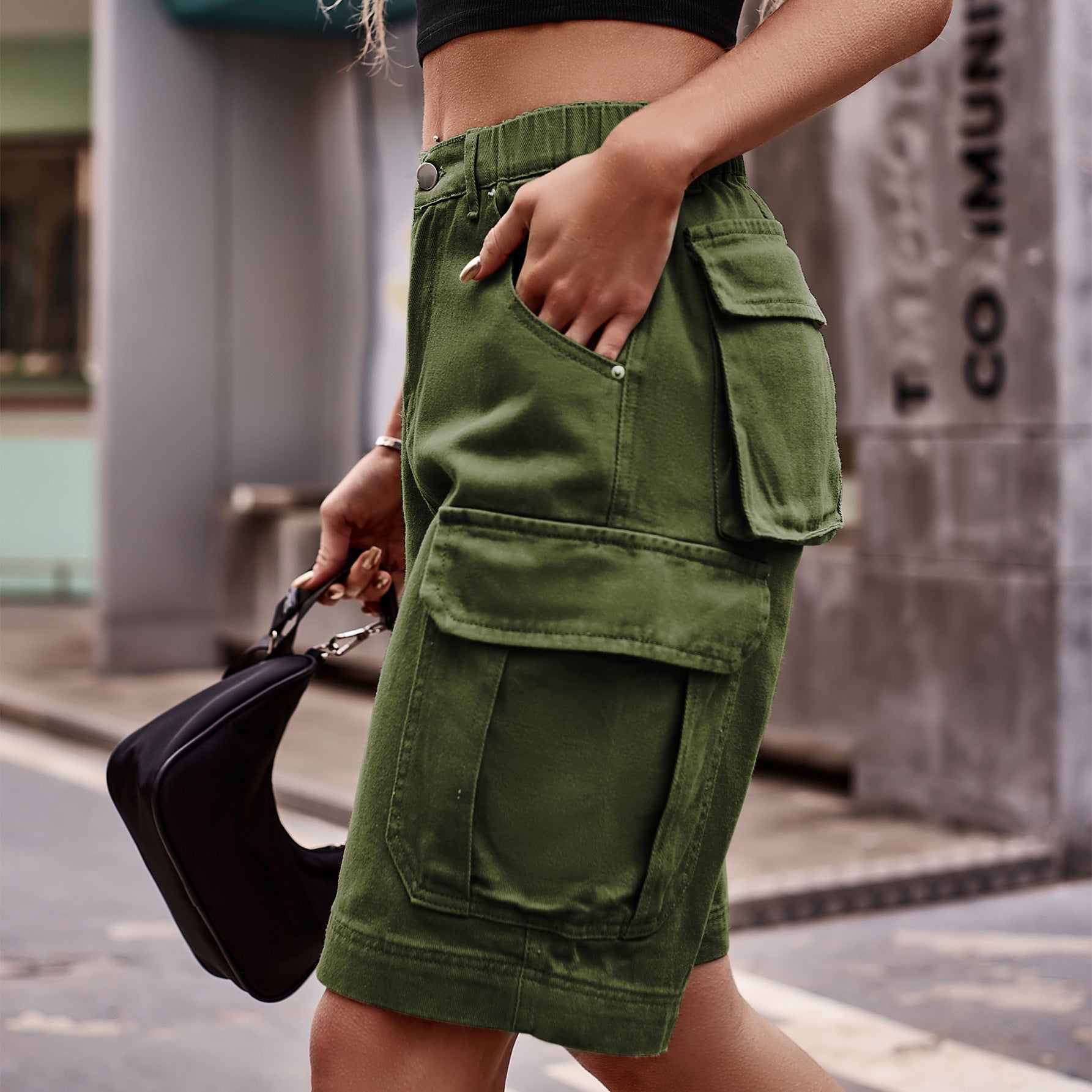 Army green denim cargo shorts with multiple pockets and elastic waistband.