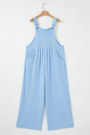 Light blue checkered textured jumpsuit with button straps and wide legs.
