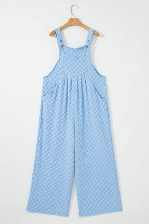 Light blue checkered textured jumpsuit with button straps and wide legs.