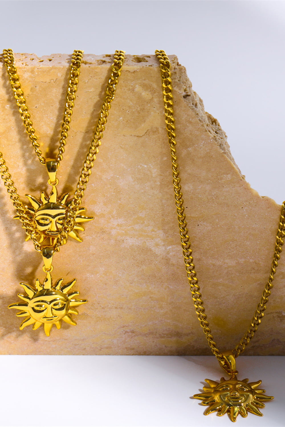 Gold sunburst pendant necklaces with curb chains