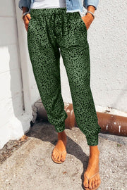 Green leopard print drawstring trousers with a relaxed fit and cuffed ankles.