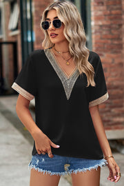 Black V-neck blouse with lace trim on neckline and sleeves