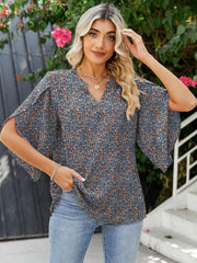 Navy floral v-neck blouse with flutter sleeves and split cuffs, made of 100% polyester.