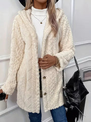 Cream fuzzy hooded trench coat with button detail and textured pattern.