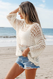 Beige openwork knit beach cover-up with long sleeves and a relaxed fit.