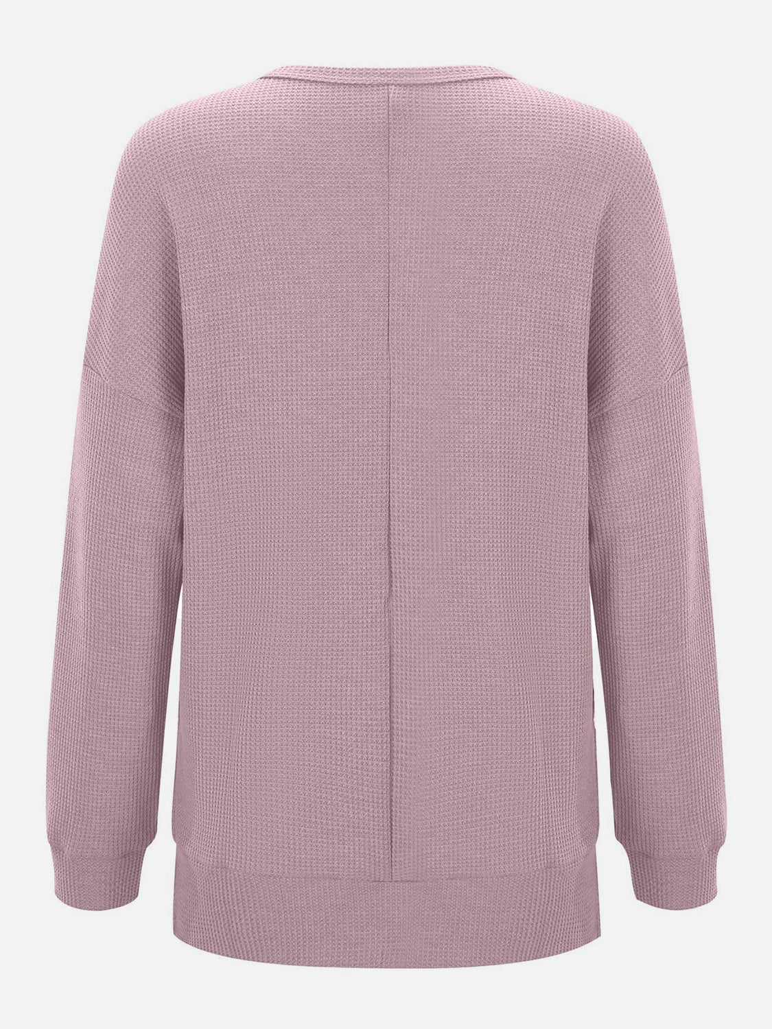 Dusty pink waffle knit crewneck top with relaxed fit and long sleeves.