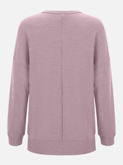 Dusty pink waffle knit crewneck top with relaxed fit and long sleeves.